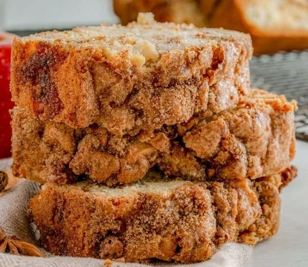 Delicious apple bread with a cinnamon swirl slice on a wooden table