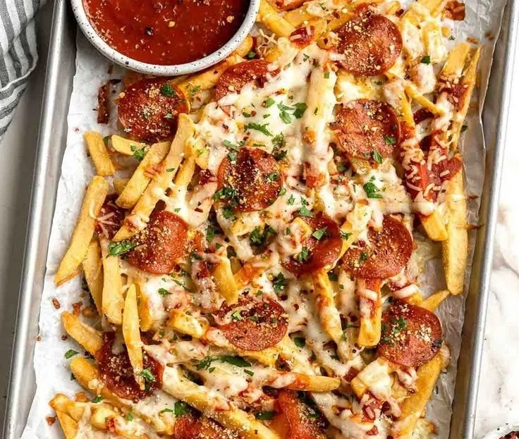 Delicious homemade baked pizza fries topped with cheese and spices