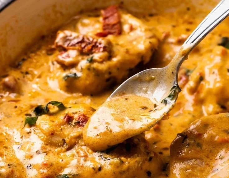 Creamy keto chicken dish garnished with herbs and served on a plate.