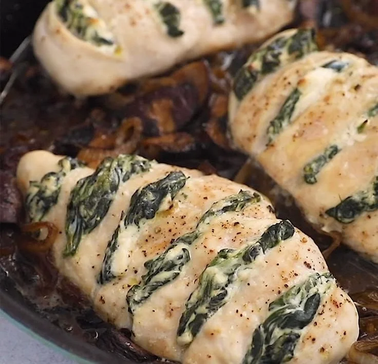 Goat cheese and spinach stuffed chicken breast on a plate