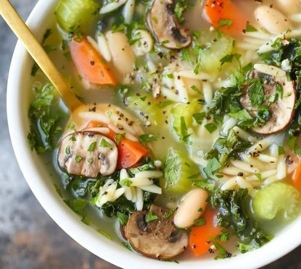 Bowl of healthy chicken and vegetable soup with fresh ingredients