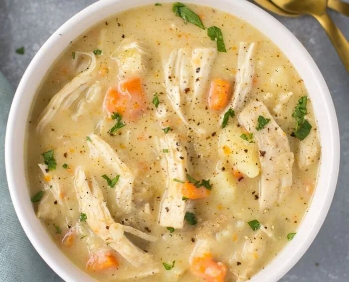 Bowl of healthy chicken pot pie soup with vegetables and chicken