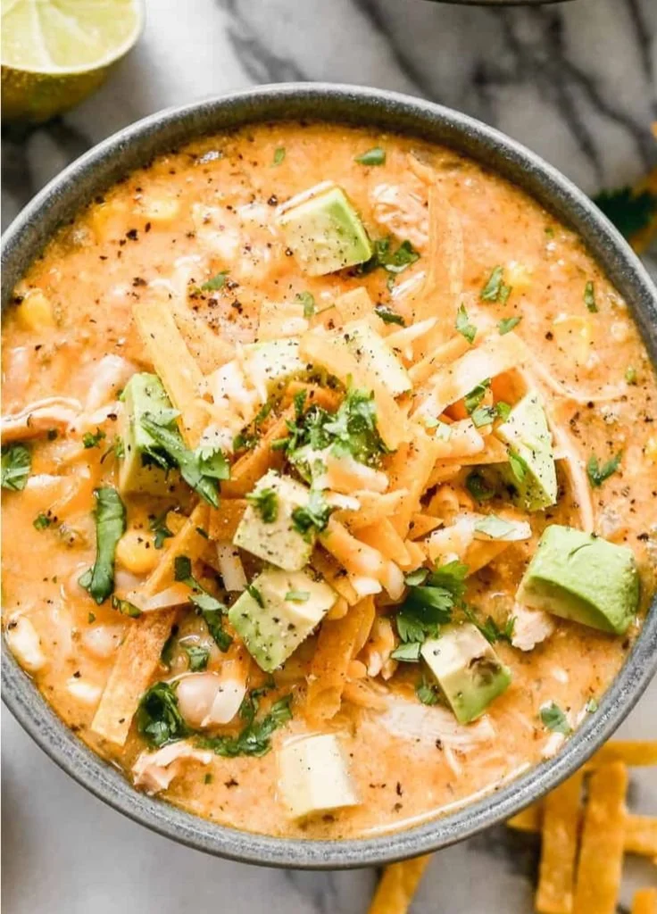 Bowl of healthy white chicken chili garnished with herbs and spices