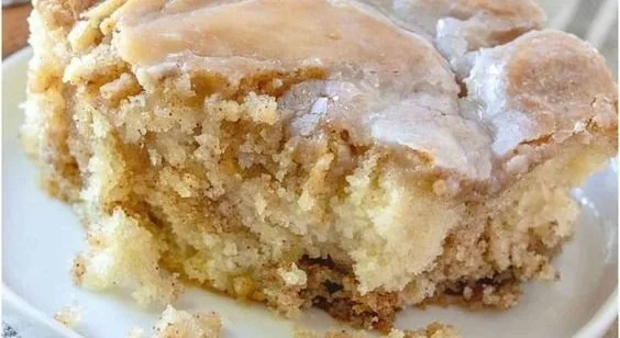 Delicious homemade cinnamon roll cake with icing and cinnamon swirl topping.