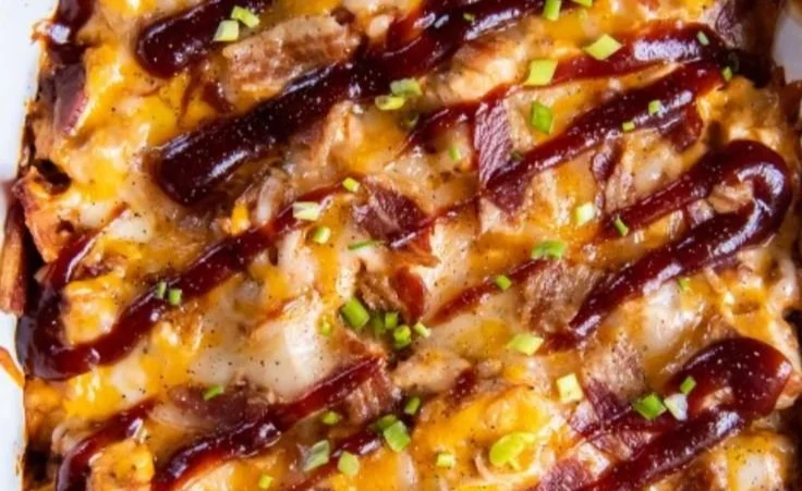 Keto BBQ Chicken Casserole topped with cheese and herbs
