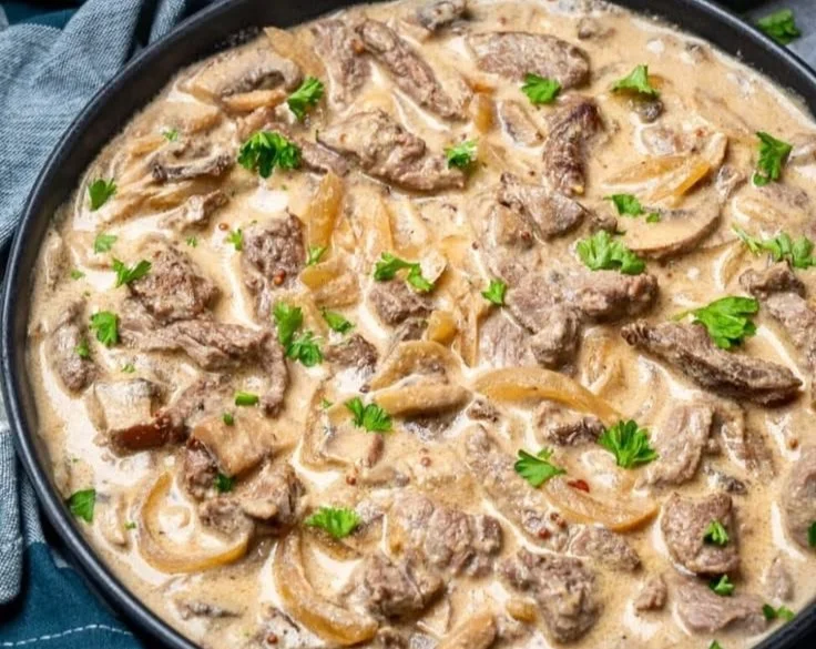 Creamy Keto Beef Stroganoff served in a bowl with mushrooms and herbs.