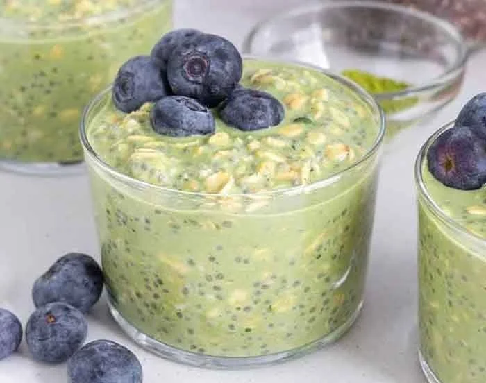 Bowl of Matcha Overnight Oats topped with fruits and nuts