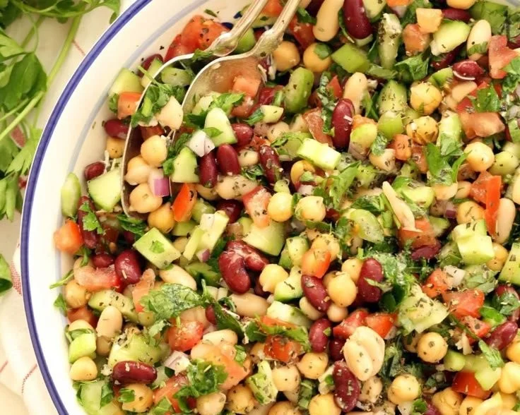 Delicious Mediterranean bean salad in a bowl with fresh vegetables and herbs