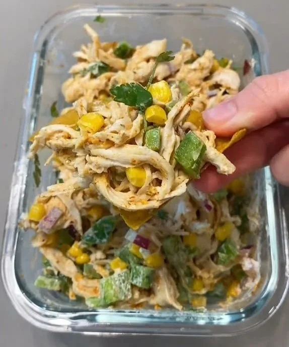 Mexican-Style Chicken Salad with avocados and corn in a vibrant bowl