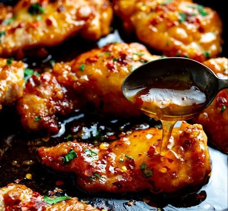 Delicious plate of Minute Honey Garlic Chicken with fresh herbs and garlic.